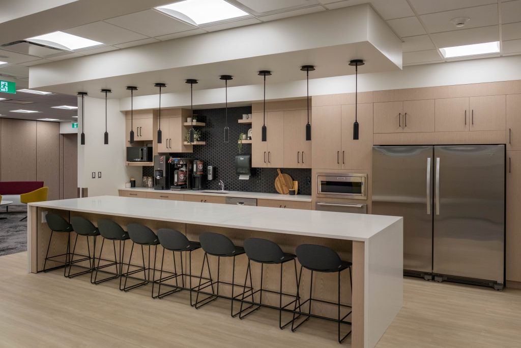 Another angle from the right of the central island featuring Maple White Quartz with warm blonde cabinetry.